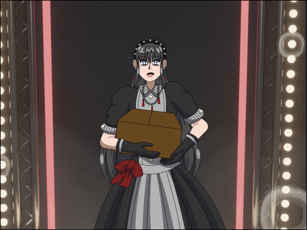 Image Description: A close-up of Trish on stage. She looks a bit nervous and is holding a cardboard box in front of her.
